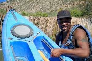 This is Cameron, one of our guides. He is getting the kayaks over the diversion dam. 