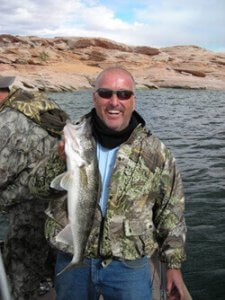 WORKS WHEREVER — As a big (and successful) advocate of the “mixing-it-up” tactics, angler Mike Wallace shows a nice walleye caught at Lake Powell. As a matter of fact, he has photos of several species (including a huge Montana trout) from several waterways that have succumbed to his fishing technique.